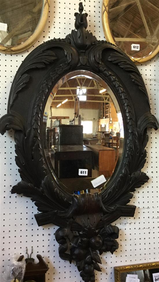 Carved oak oval wall mirror